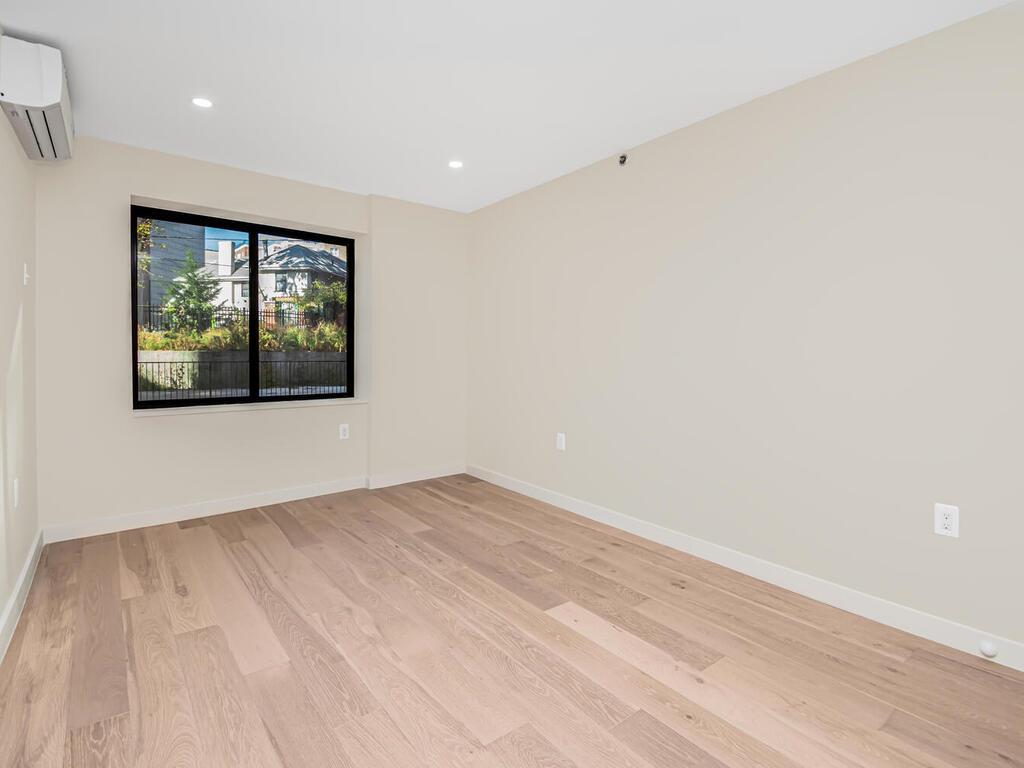 3641 Johnson Avenue, Unit B B Bronx, NY 10463 - Photo 2 of 3 an empty room with wooden floor and windows