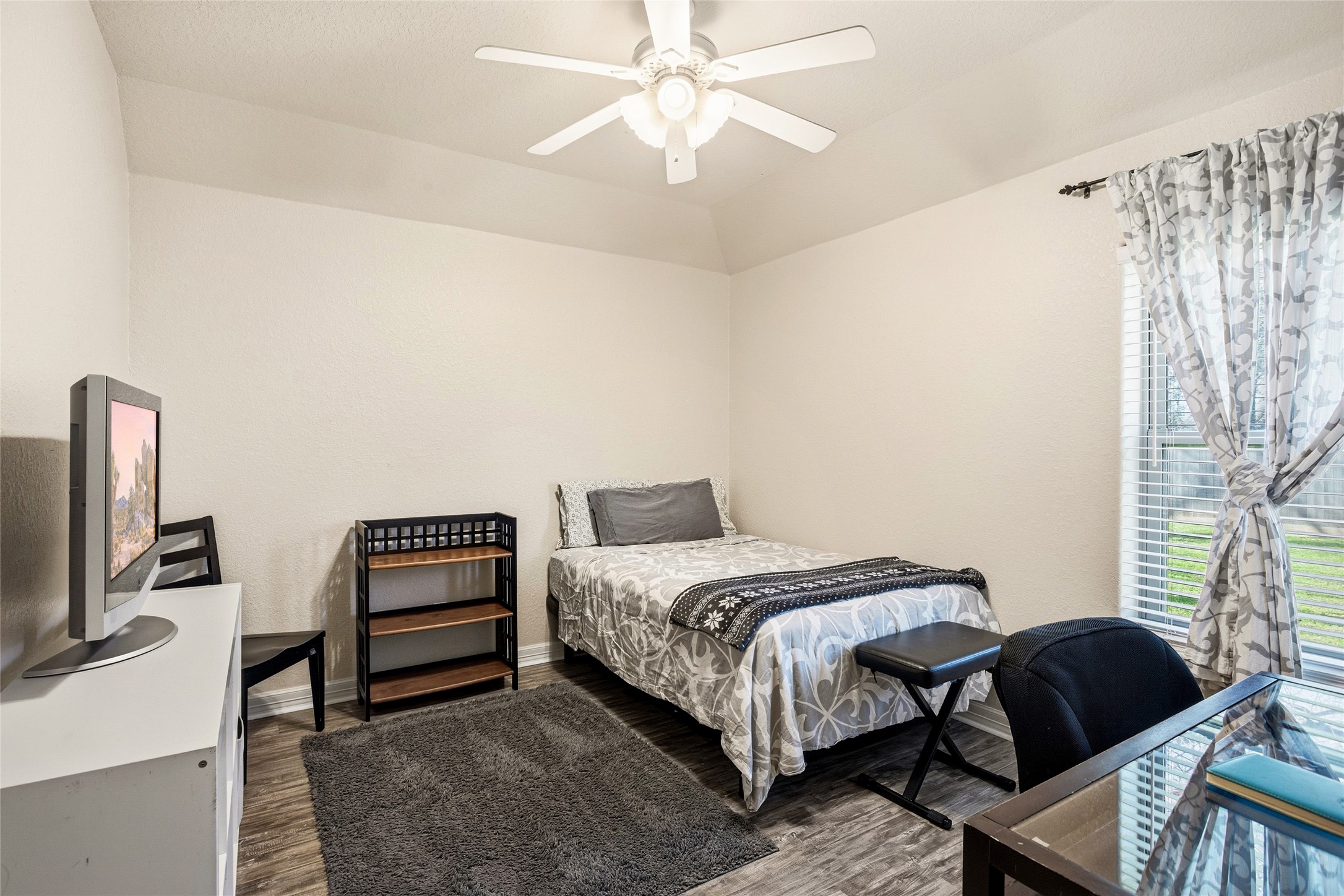 104 Hamilton Clute, TX 77531 - Photo 14 of 25 a bedroom with a bed and a chandelier