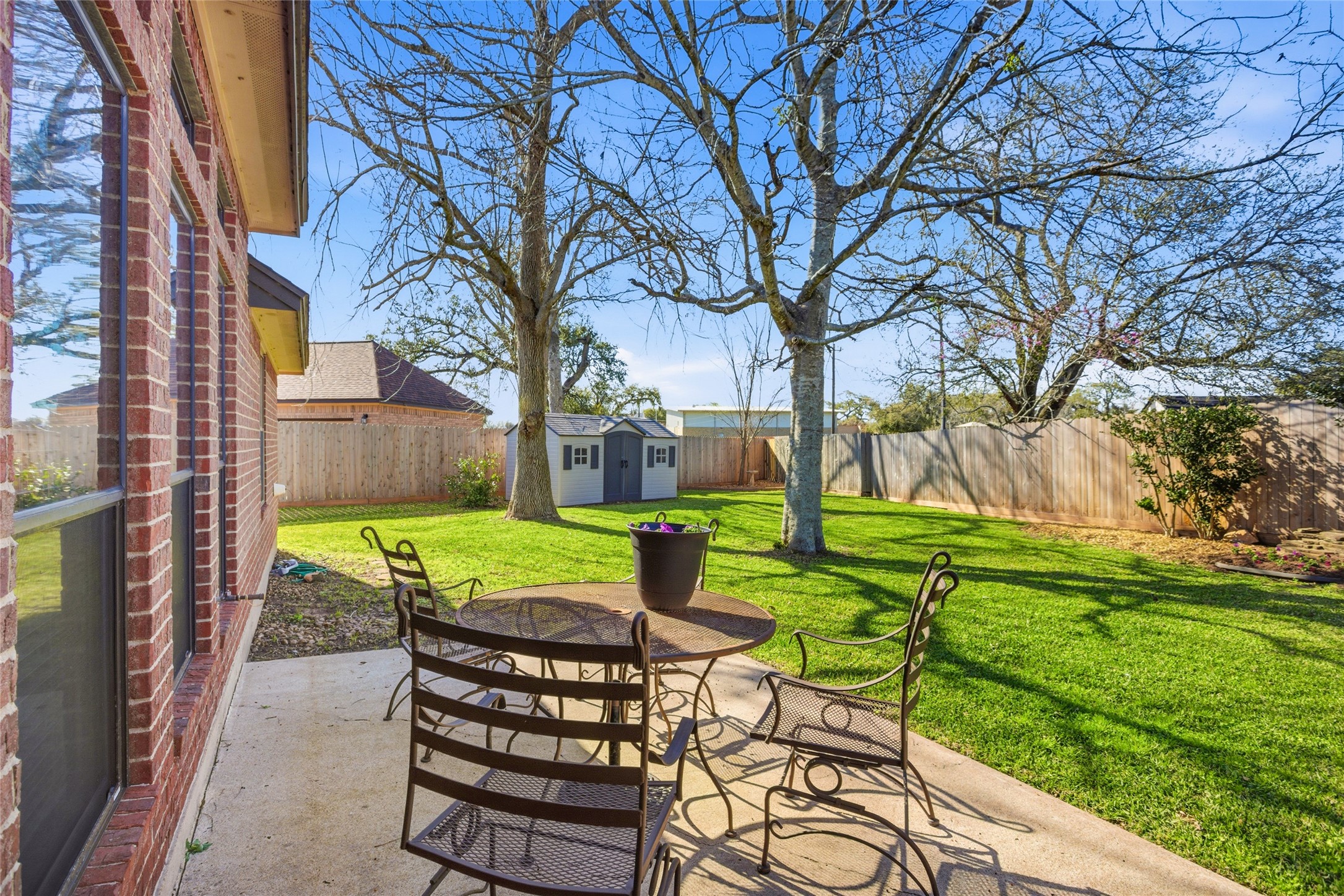 104 Hamilton Clute, TX 77531 - Photo 19 of 25 a view of a table and chairs in the backyard of the house