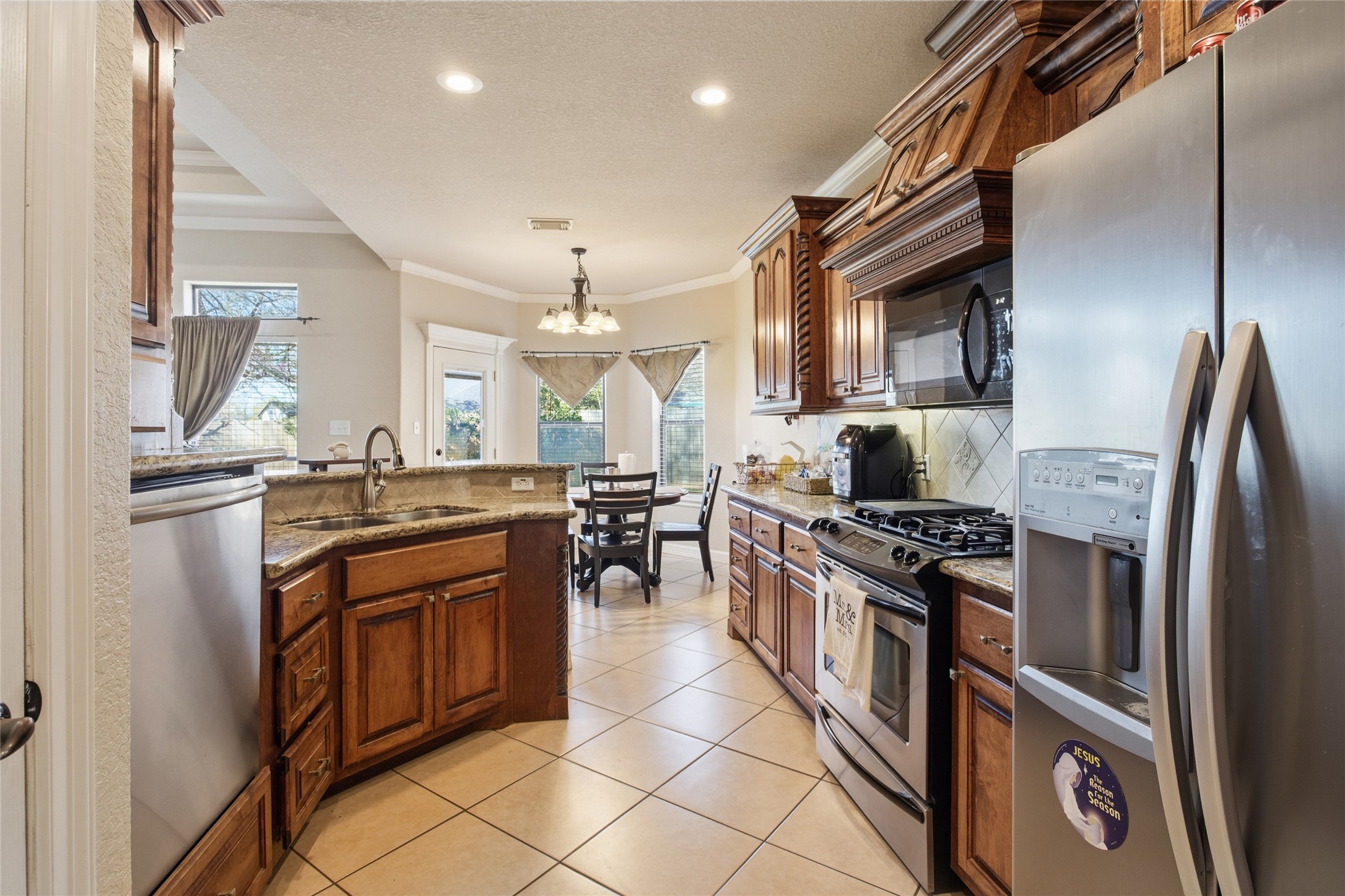 104 Hamilton Clute, TX 77531 - Photo 6 of 25 a kitchen with stainless steel appliances granite countertop a stove top oven a sink and a refrigerator