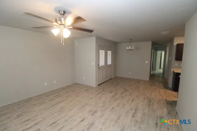 a view of an empty room and wooden floor