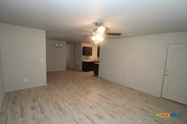 wooden floor in an empty room with a cabinet