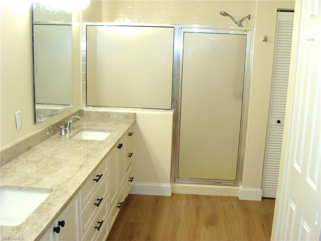 857 Reef Point Circle Naples, FL 34108 - Photo 14 of 27 a bathroom with a granite countertop sink and a mirror
