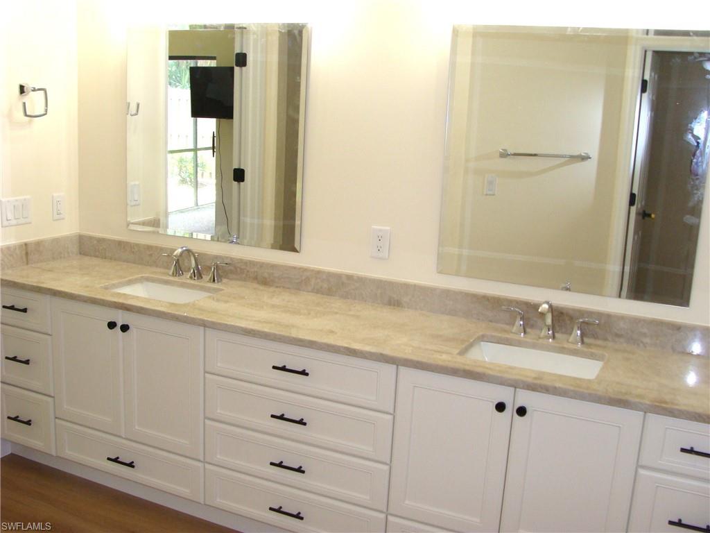 857 Reef Point Circle Naples, FL 34108 - Photo 15 of 27 a bathroom with a granite countertop sink and a mirror