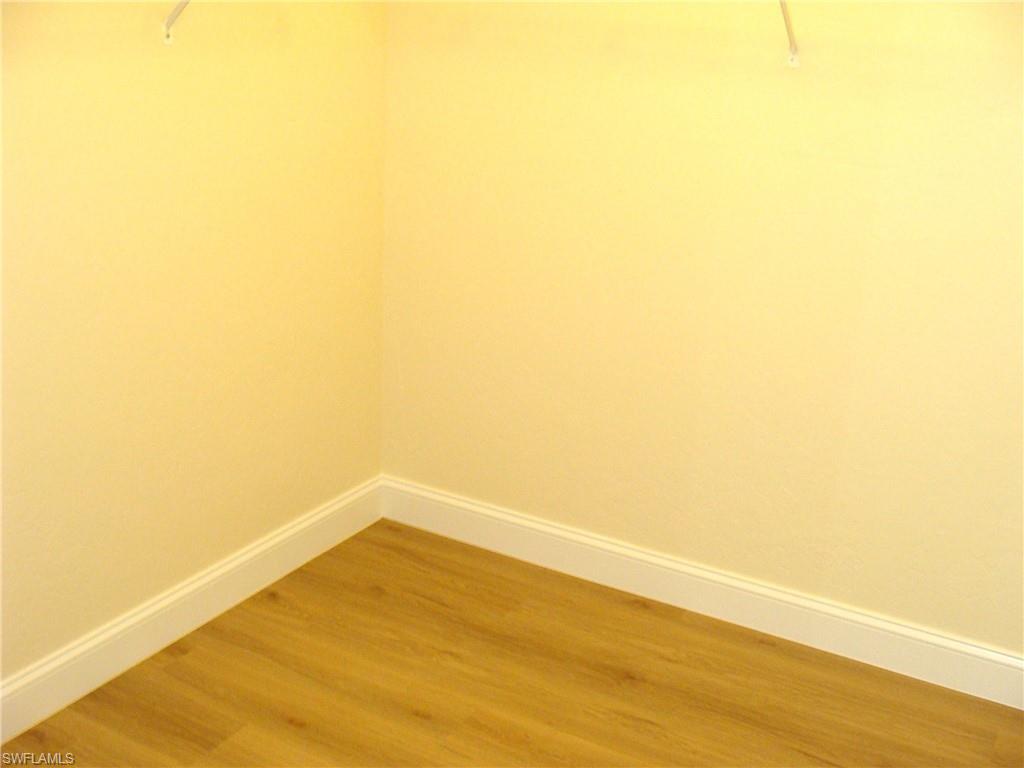 857 Reef Point Circle Naples, FL 34108 - Photo 16 of 27 a view of empty room with wooden floor