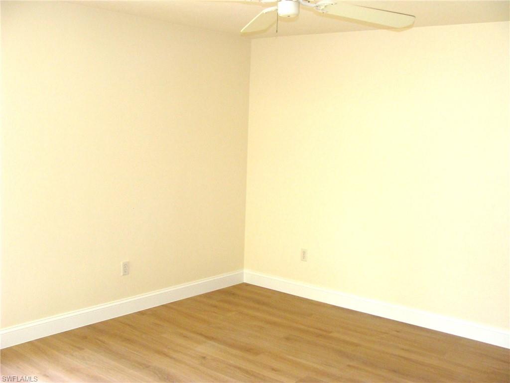 857 Reef Point Circle Naples, FL 34108 - Photo 19 of 27 a view of empty room with wooden floor