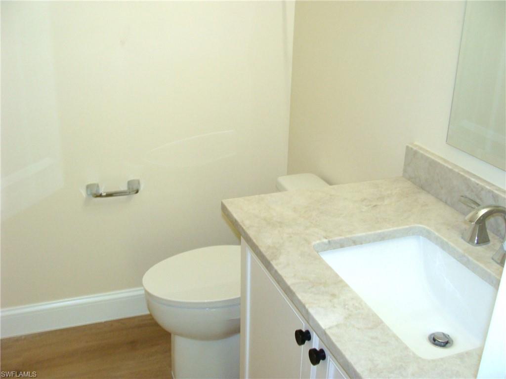 857 Reef Point Circle Naples, FL 34108 - Photo 20 of 27 a bathroom with a granite countertop sink and a mirror