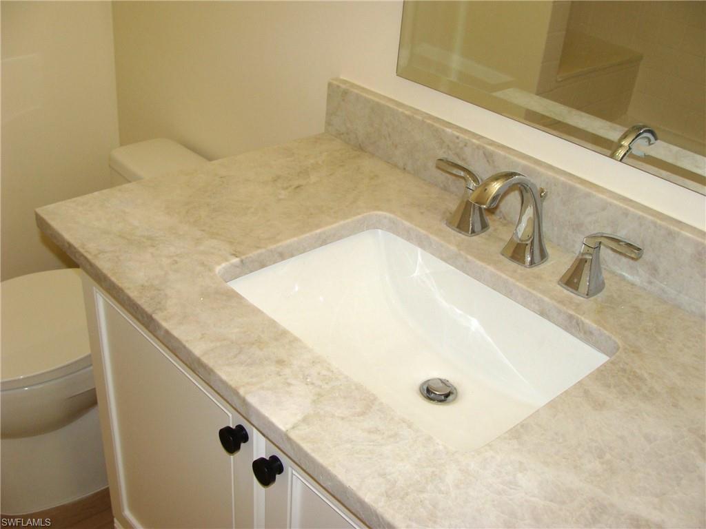 857 Reef Point Circle Naples, FL 34108 - Photo 21 of 27 a bathroom with a granite countertop sink and