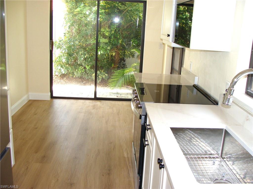857 Reef Point Circle Naples, FL 34108 - Photo 6 of 27 a view of a kitchen with a sink and wooden floor