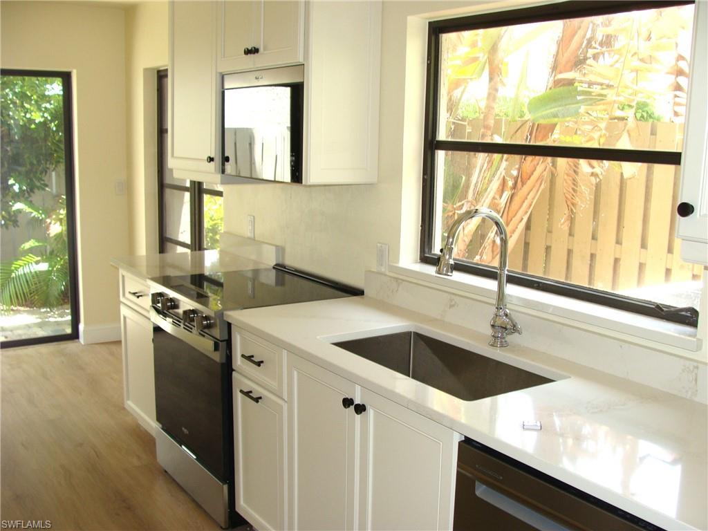 857 Reef Point Circle Naples, FL 34108 - Photo 7 of 27 a kitchen with a sink and a window