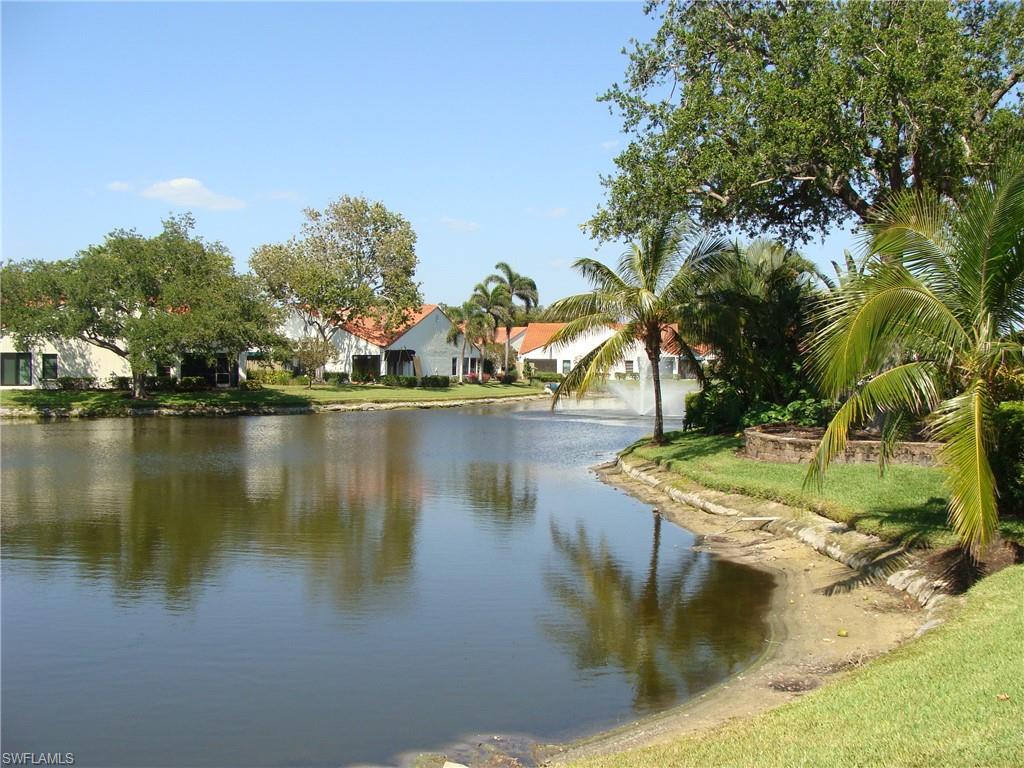 857 Reef Point Circle Naples, FL 34108 - Photo 8 of 8 a view of a lake with houses