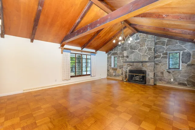 a view of an empty room with a fireplace and a window