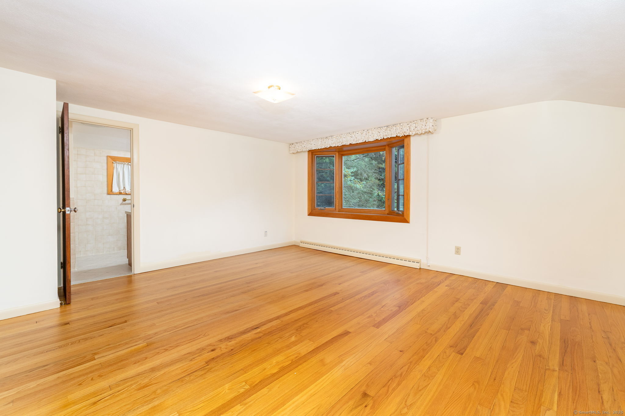 418 Plymouth Road Harwinton, CT 06791 - Photo 19 of 37 a view of an empty room with wooden floor and a window