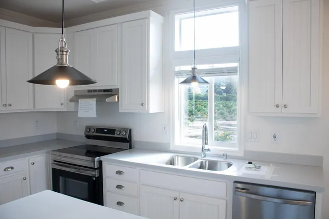 a kitchen with a sink a window and cabinets