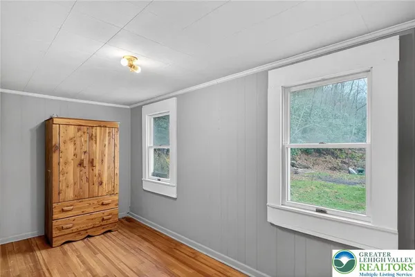 a view of room with window and wooden floor