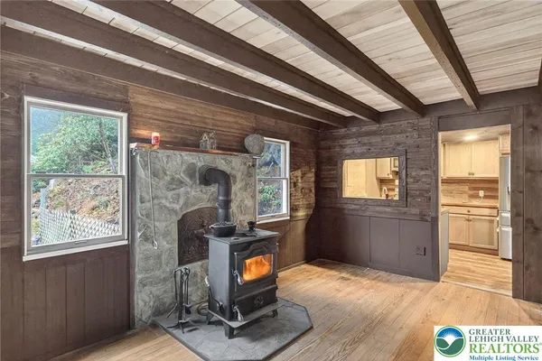 a view of a hallway with wooden floor and windows