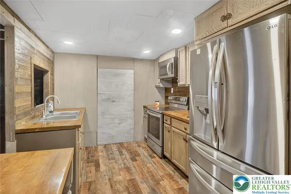 a kitchen with stainless steel appliances a refrigerator and a sink