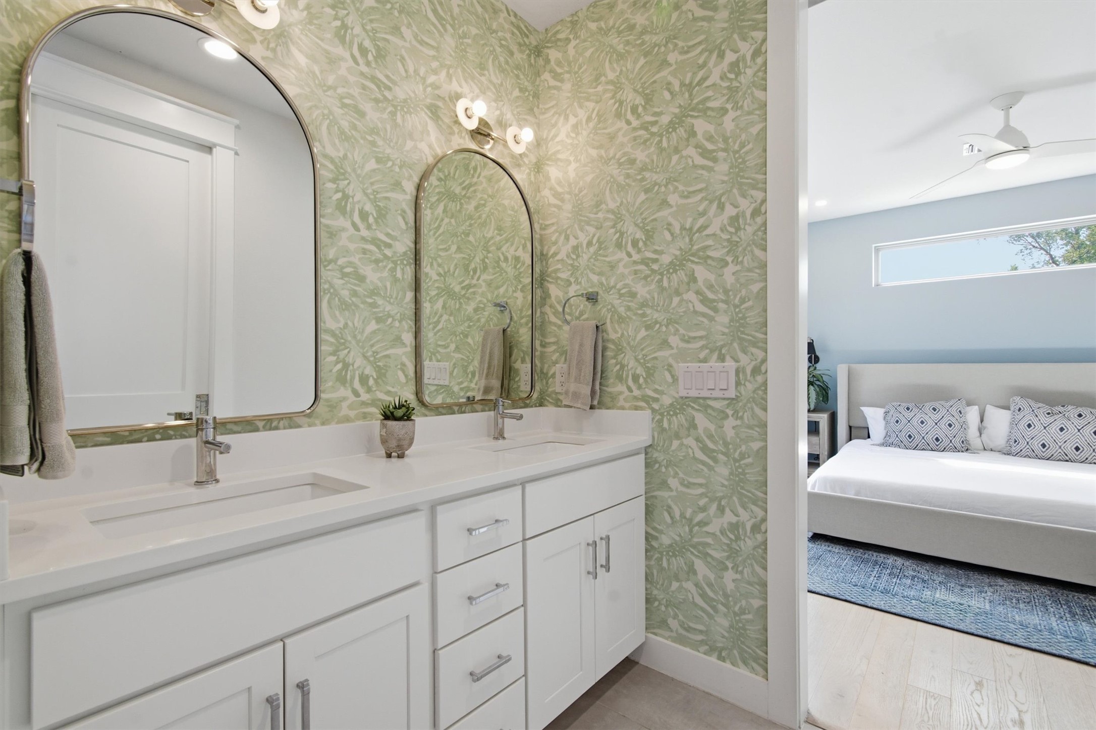 2710 Zaragosa Street, Unit A Austin, TX 78702 - Photo 17 of 29 Elegant dual-vanity bath with statement tile, arched mirrors, and crisp white cabinetry.