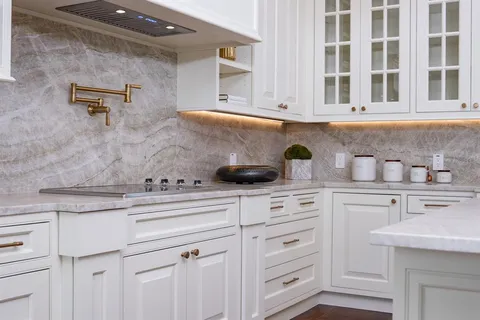 a kitchen with white cabinets and white appliances