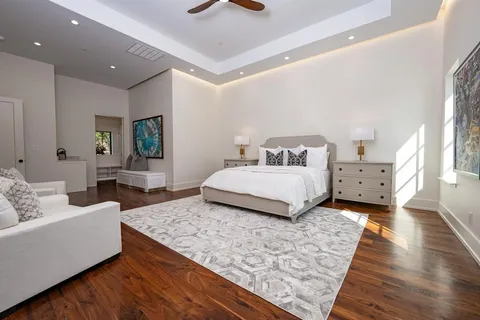 a spacious bedroom with a bed and a couch