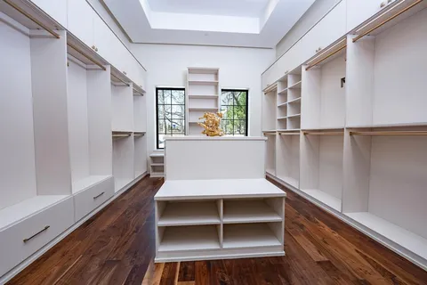 a view of walk in closet with empty racks