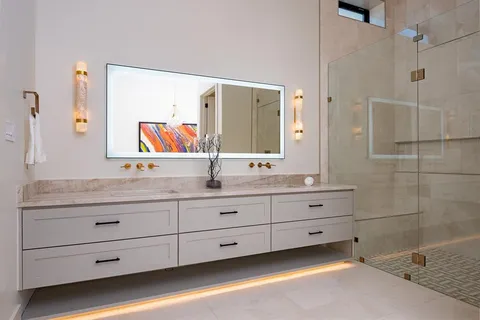 a bathroom with a granite countertop sink mirror and double