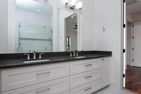 a bathroom with double sink and a mirror