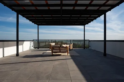 a roof deck with a table and chairs