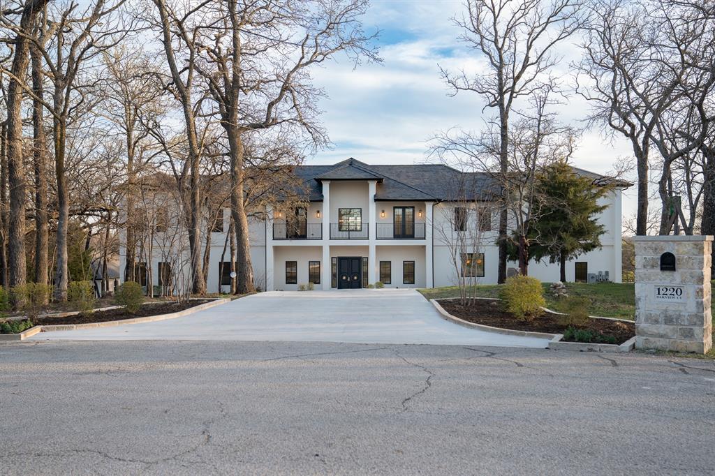 1230 Oak View Court Oak Point, TX 75068 - Photo 32 of 33 a front view of a house with a yard and large trees