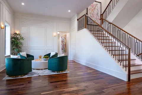 a view of entryway and hall with wooden floor
