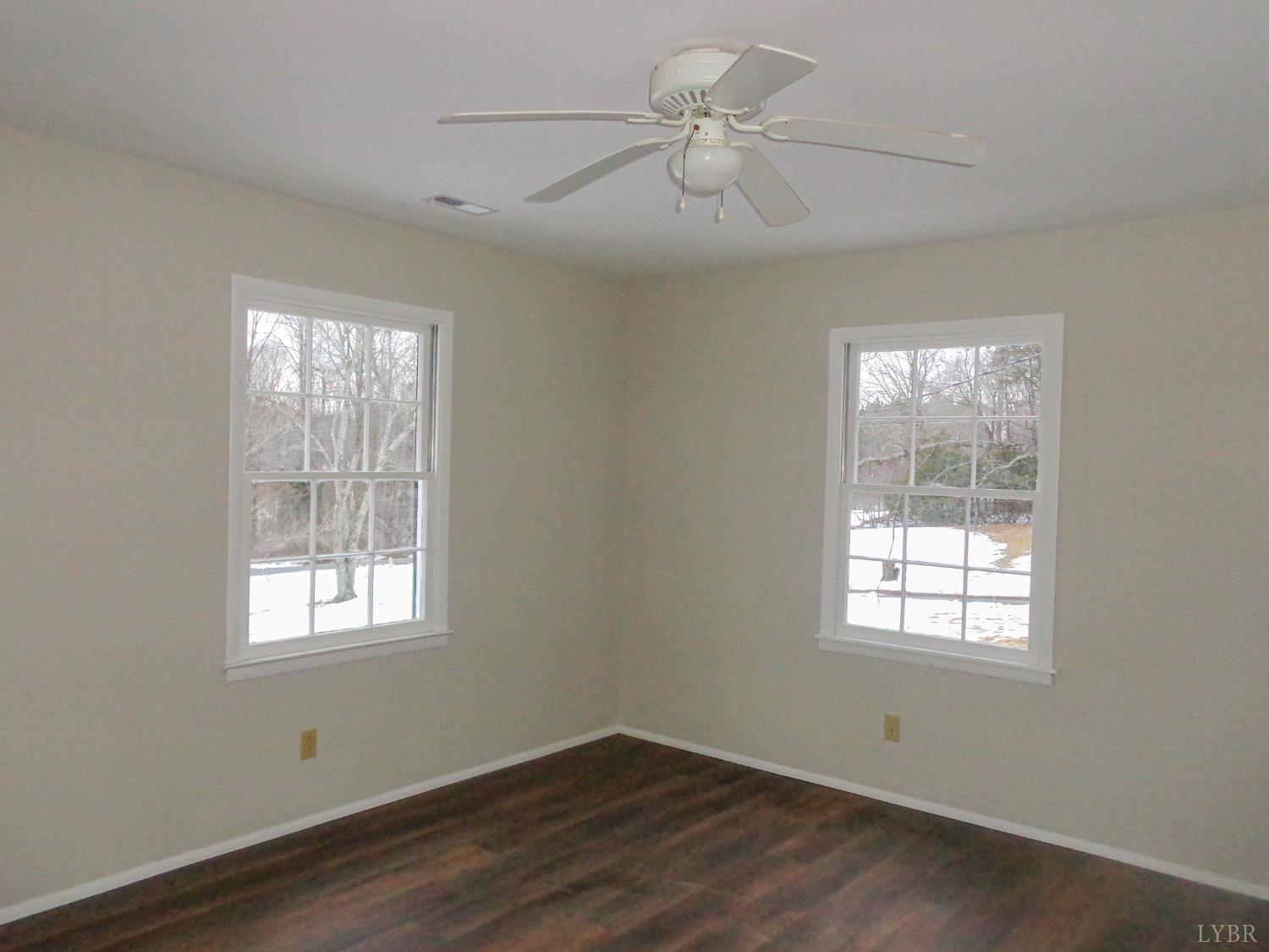 1136 Staunton Hill Road Brookneal, VA 24528 - Photo 12 of 22 a view of empty room with wooden floor and fan