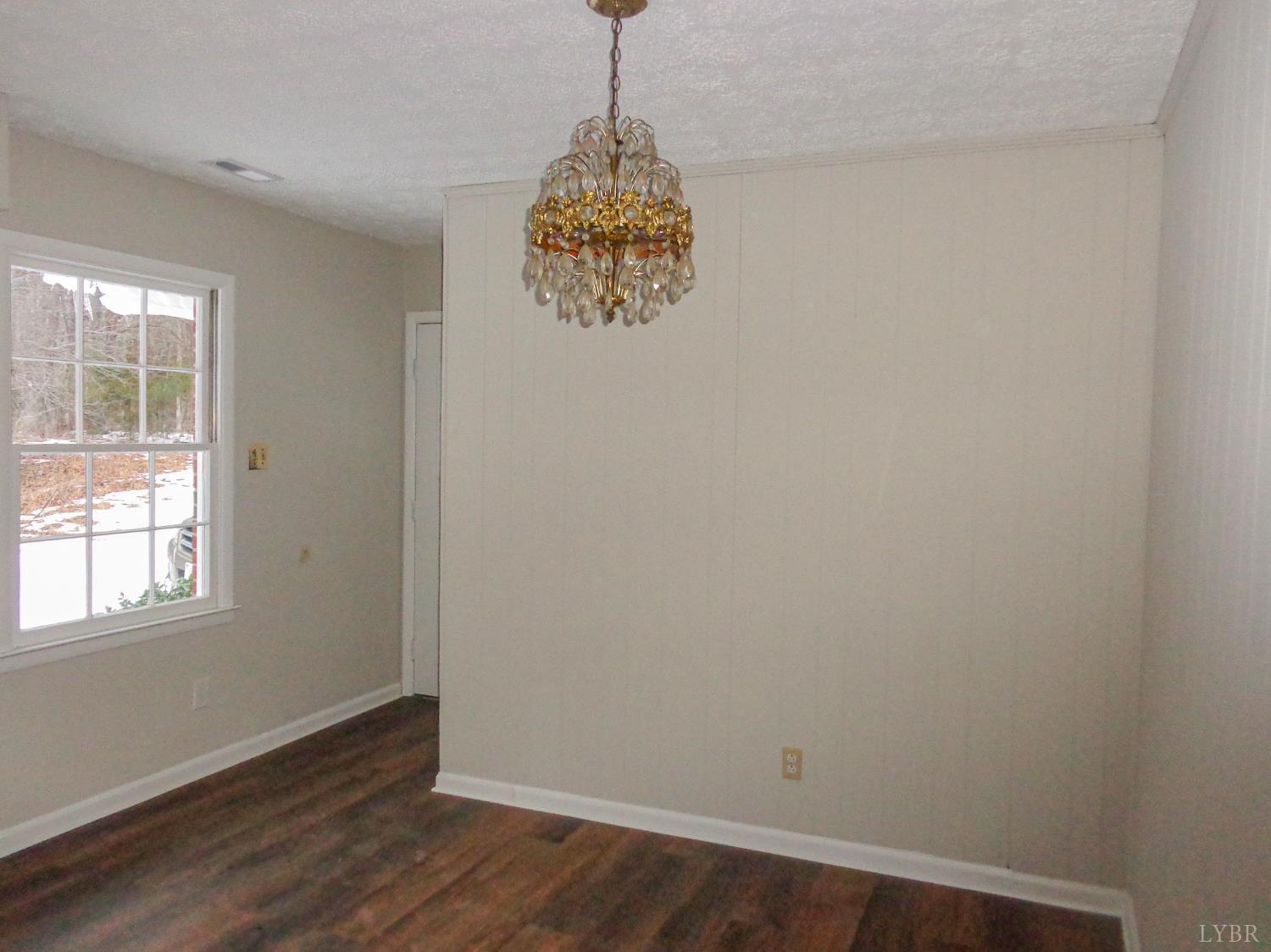 1136 Staunton Hill Road Brookneal, VA 24528 - Photo 14 of 22 an empty room with wooden floor and windows