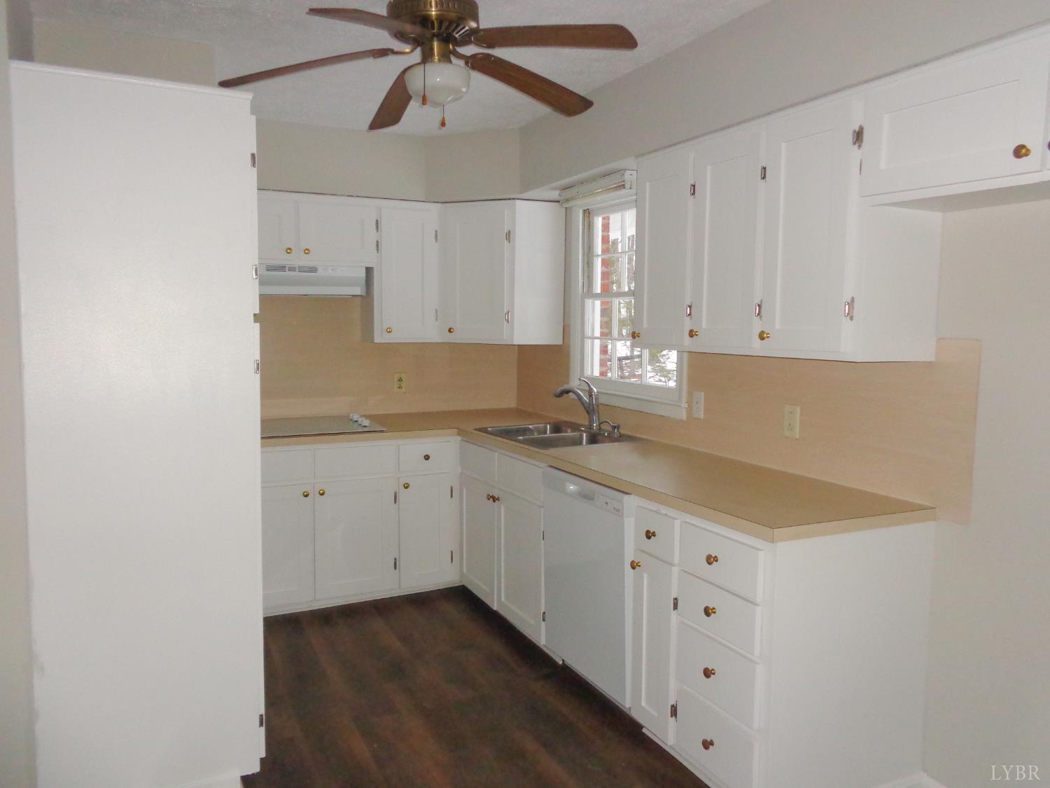 1136 Staunton Hill Road Brookneal, VA 24528 - Photo 7 of 22 a kitchen with granite countertop white cabinets and white appliances