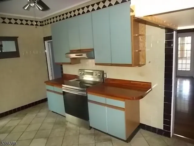 a kitchen with granite countertop a stove and a sink