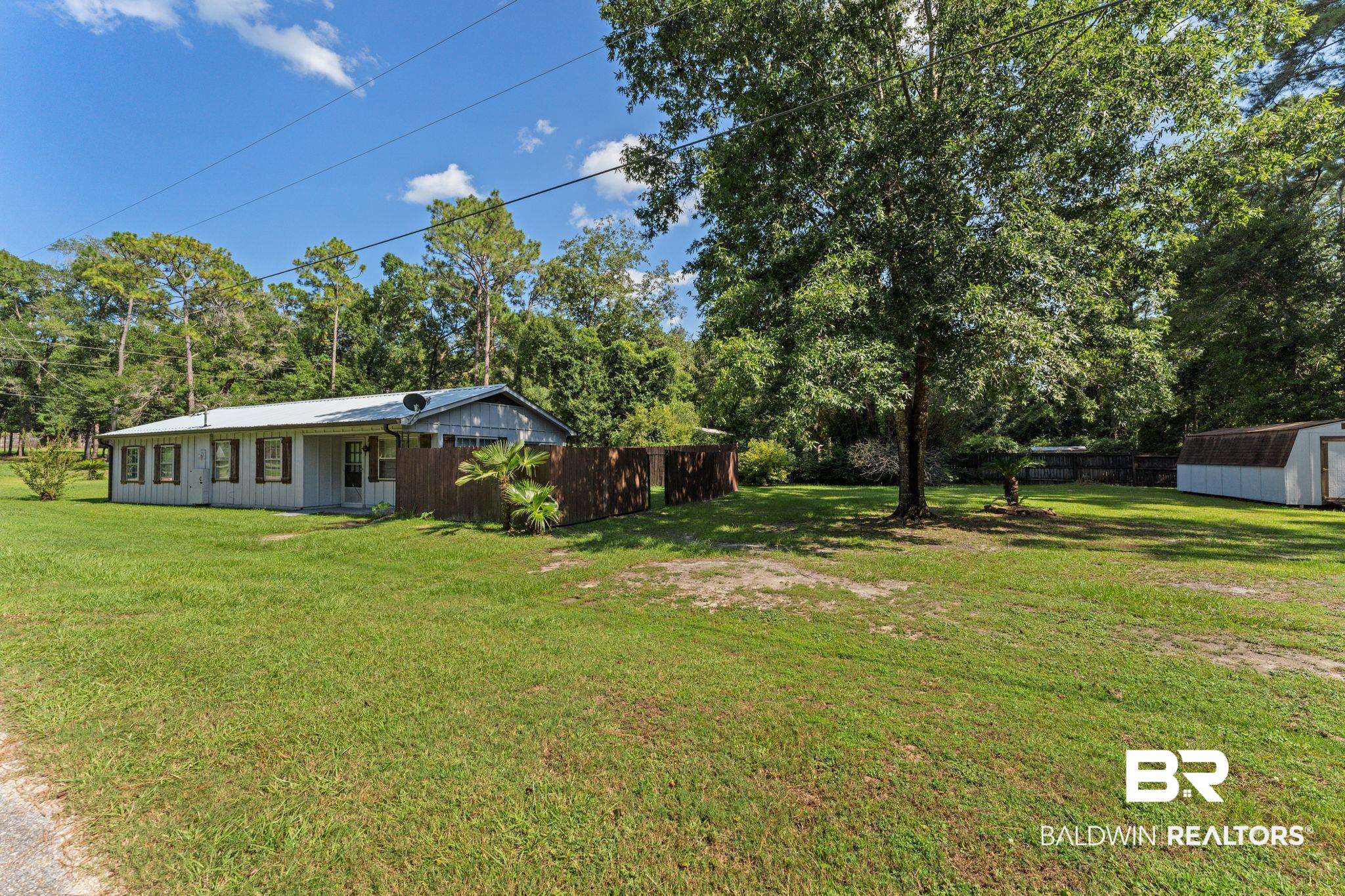 14095 Riverside Drive Foley, AL 36535 - Photo 3 of 30 View of yard featuring a shed and view of scattered trees