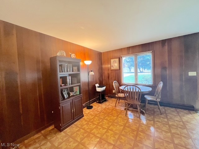 Dining room featuring wooden walls