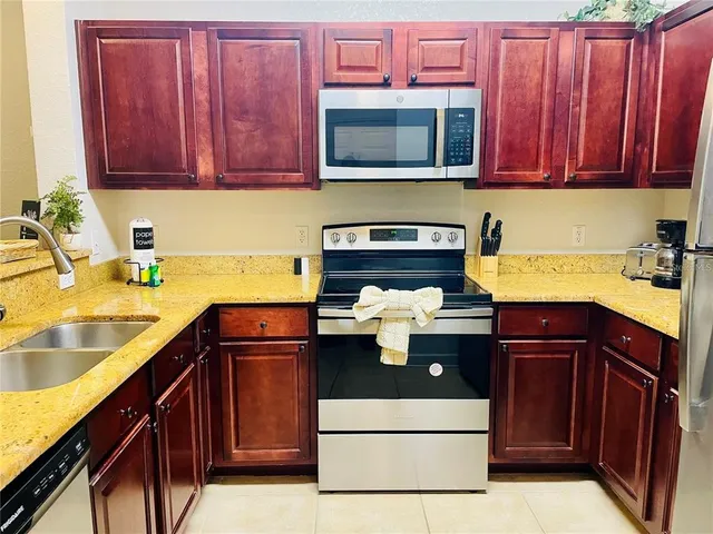 a kitchen with a sink stove and microwave