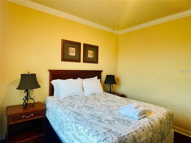 a bedroom with a bed and a lamp