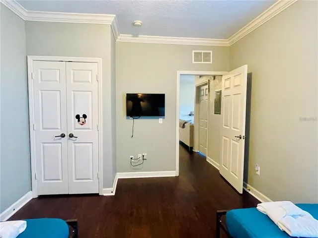 a view of a livingroom with wooden floor and a flat screen tv