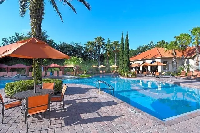 a patio with a table and chairs under an umbrella
