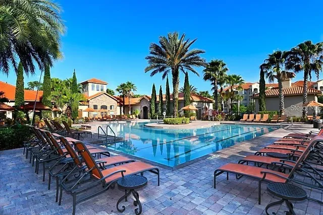 a backyard of a house with barbeque oven table and chairs