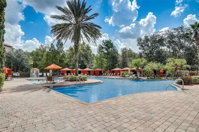 a view of a backyard with swimming pool