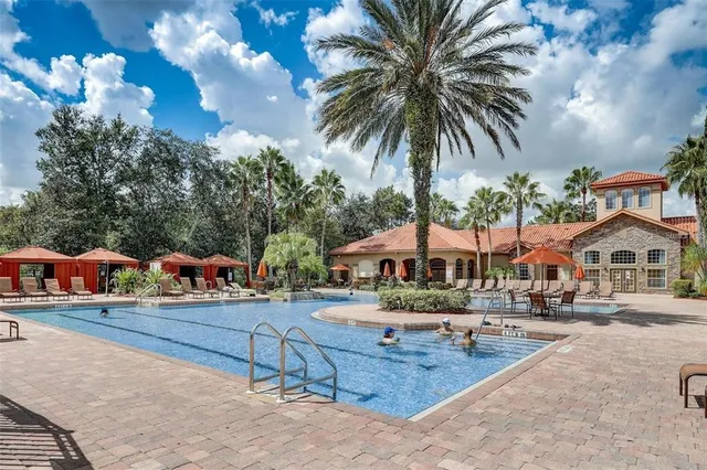 a swimming pool with outdoor seating and yard