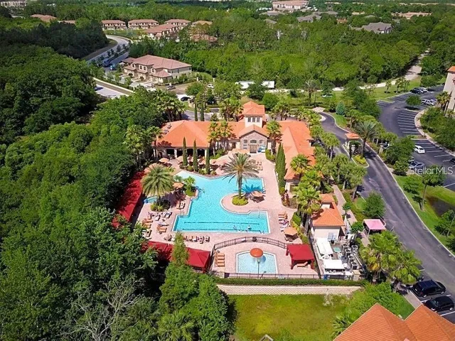 an aerial view of residential houses with outdoor space and swimming pool