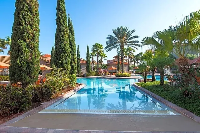 a view of backyard with swimming pool and outdoor seating
