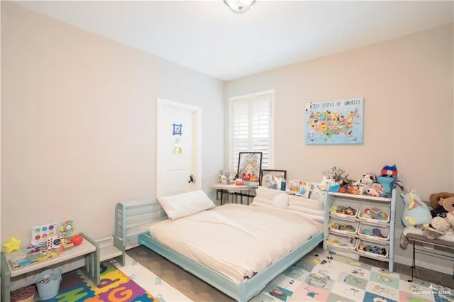 a bedroom with a bed and a bookshelf