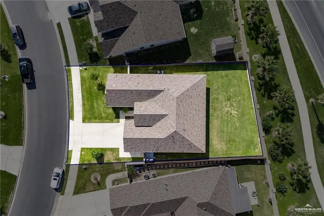 an aerial view of house with a yard
