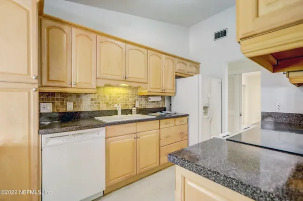 a kitchen with stainless steel appliances granite countertop a sink and cabinets