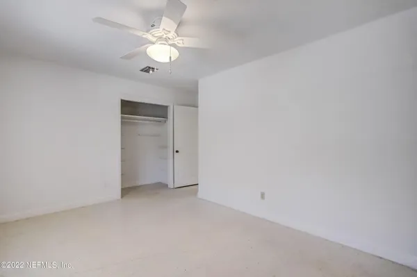 a view of a room with lounge chair windows and wooden floor