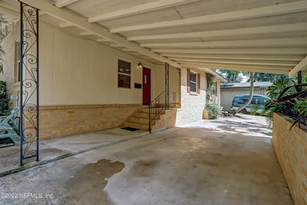 a view of a patio with table and chairs and potted plants